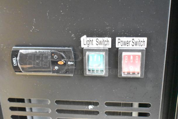 Close-up of control panel on Avantco 178UBB48GHC bar fridge showing light and power switches. Scratch marks visible.