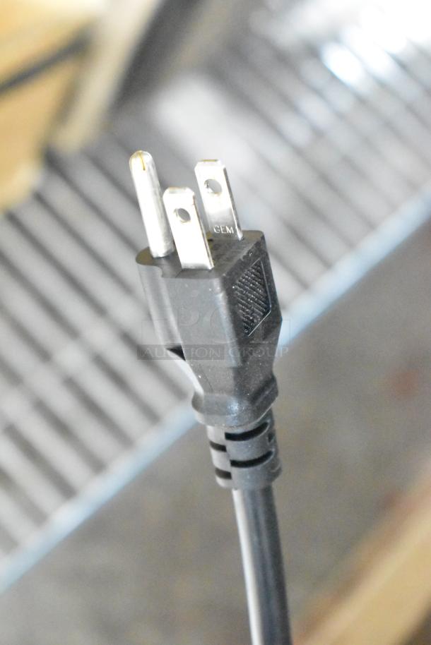 Close-up view of the power plug for a 2024 Avantco 178UBB48GHC back bar refrigerator, showing a standard three-prong design.