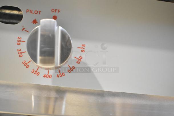 Stainless steel gas griddle control knob with temperature markings, showing range from 200°F to 575°F, labeled "PILOT," "OFF."