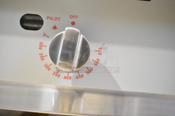 Cooking Performance Group stainless steel gas griddle, thermostatic control knob, temperature range 200-575°F. Scratches present.
