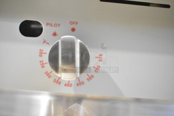 BRAND NEW Cooking Performance Group stainless steel commercial gas griddle knob with temperature markings from 200 to 575 degrees.