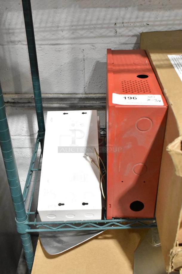 Red and white metal boxes on shelf; includes Altronix AL1002ULADA fire alarm box. Number tag "196" visible.