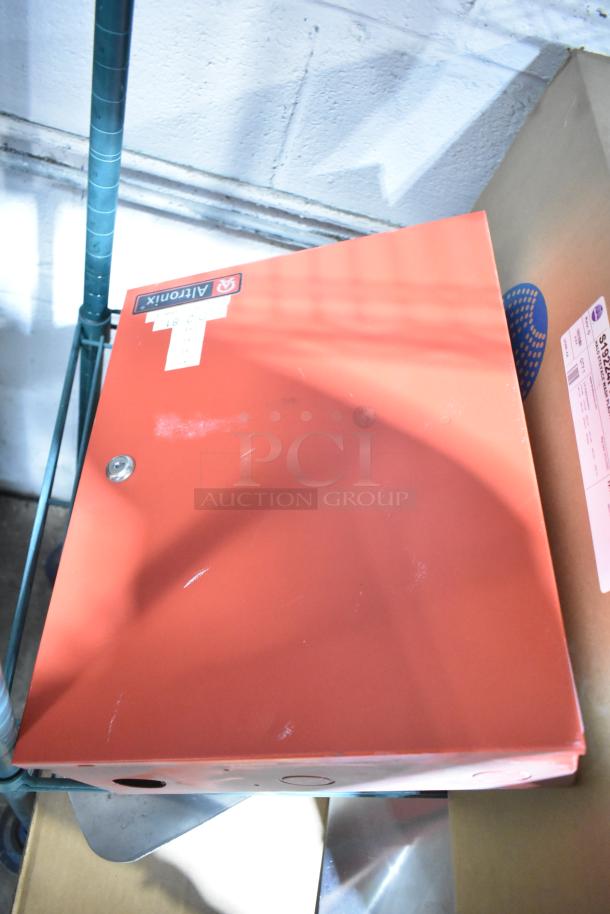 Red Altronix AL1002ULADA fire alarm box. Features Altronix label, visible wear.