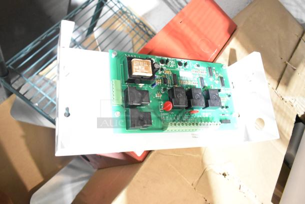 Altronix AL1002ULADA fire alarm box on cardboard. Includes circuit board and components. Slightly worn condition.