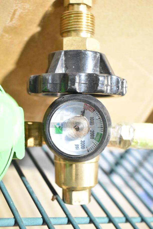 Box of 5 brand new pressure gauges, each with a black dial and markings up to 3000 psi, featuring brass fittings.