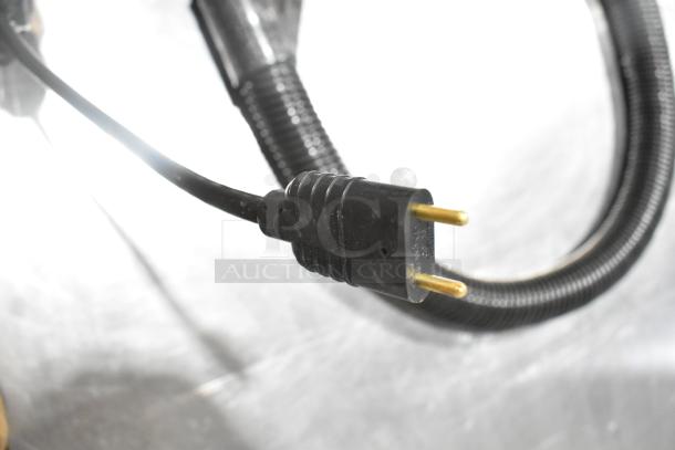 Power cord of ProTeam 1076770 GoFit 6 PH Backpack Vacuum, 120V, showing plug and part of hose, brand new condition.