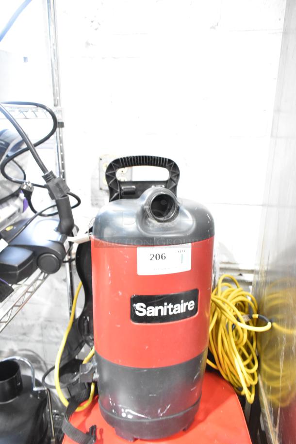 Sanitaire SC412B Backpack Vacuum, red with label, 120 volts. New scratch and dent condition. Model SC412B visible.
