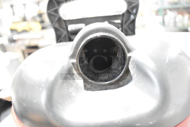 Brand new Sanitaire SC412B backpack vacuum, 120V, 1 phase, minor scratches visible, handle and suction port shown.