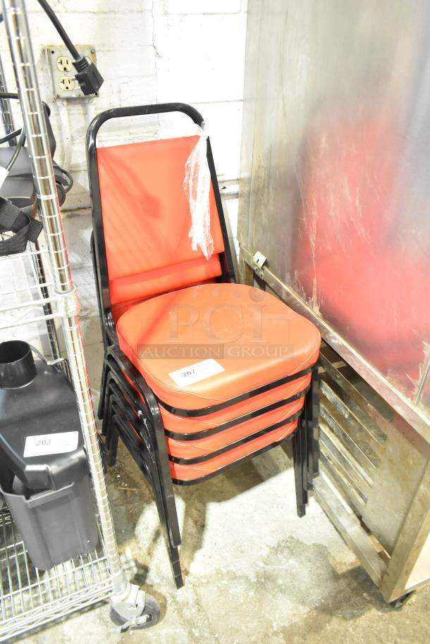 Set of 4 black metal dining chairs with red cushions. Brand new, minor scratch and dent. Lot tag 207 visible.