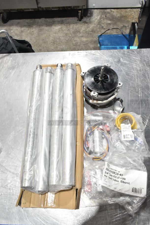 Six brand new scratch and dent items, including gas kit 089-010833-45, restraining cable, Hanning motor in packaging.