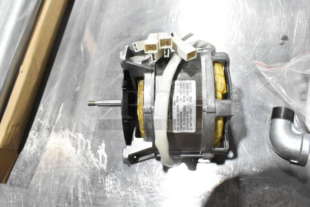 Brand new Hanning motor with visible label, part of a scratch and dent auction lot including gas kit and restraining cable.