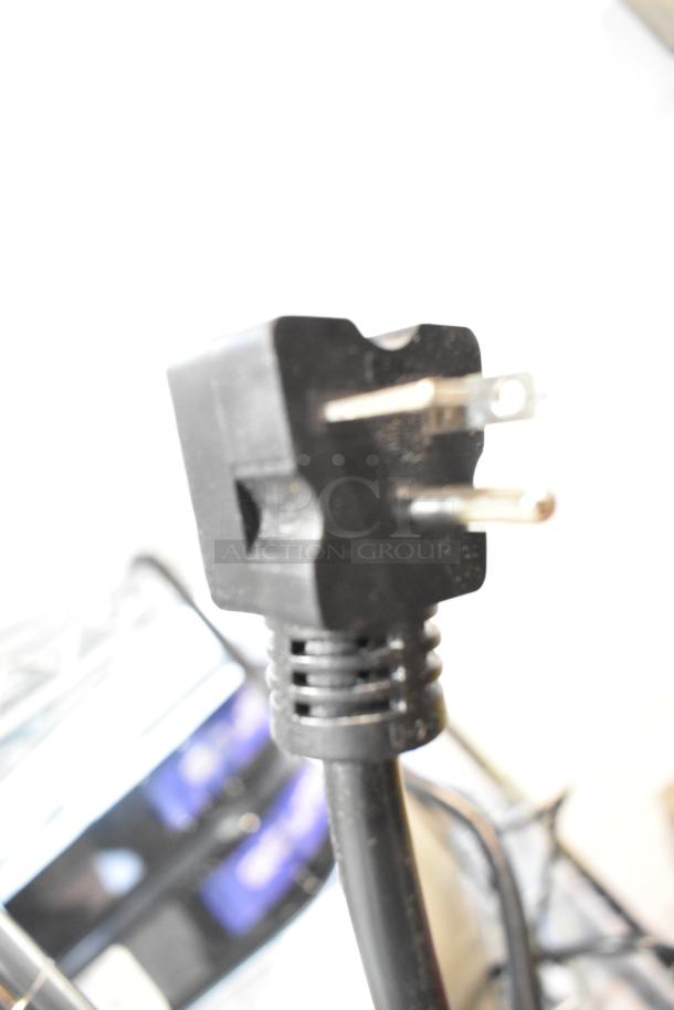 Close-up of a black three-prong plug for the Avantco 184T3300D stainless steel conveyor toaster.