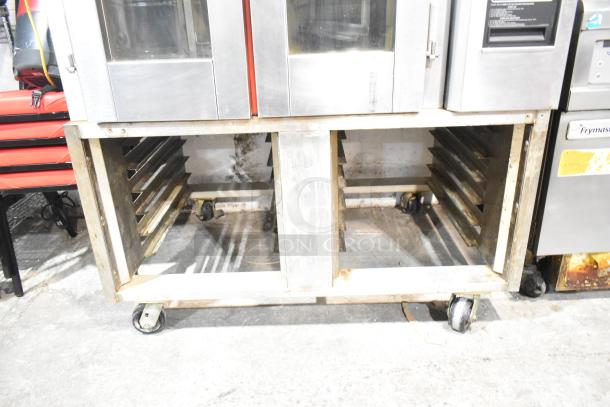 Baxter stainless steel commercial gas-powered mini rotating rack oven, 95,000 BTU, on double pan rack with casters, used condition.