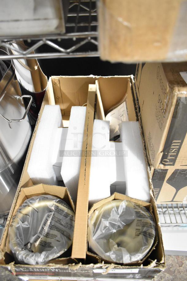 Brand new Avantco 177HLDBL24GD 24" gold double arm stainless steel heat lamp in original packaging with protective wrapping.