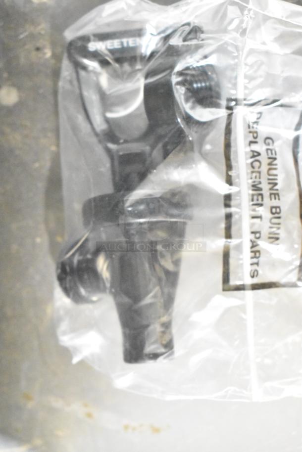 Plastic bag containing a black dispenser part labeled "Genuine Bunn Replacement Parts."