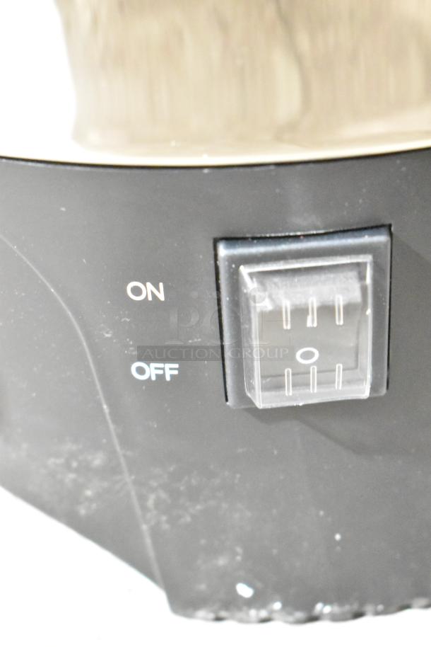Close-up of a switch on a coffee urn with "ON" and "OFF" settings, part of a Galaxy 100 Cup Stainless Steel Coffee Urn.
