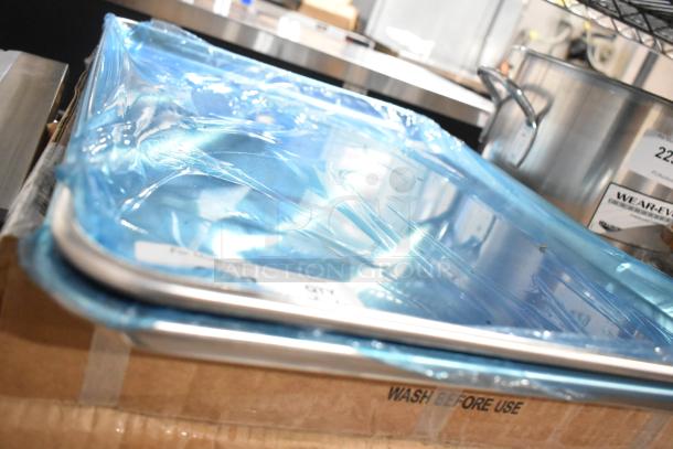 2 new Carlisle 2618FMTQ309 black fiberglass market trays, 18"x26"x1", in boxes with 2 metal full-size baking pans.