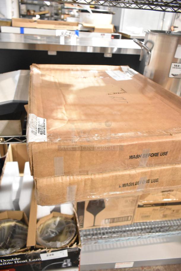 Boxes of brand new Carlisle 2618FMTQ309 black fiberglass market trays, 18"x26"x1", labeled "Wash Before Use."