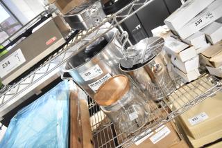 6 brand new scratch and dent items, including Anchor Hocking 96 oz. jar and Vollrath Wearever stock pot on metal shelving.