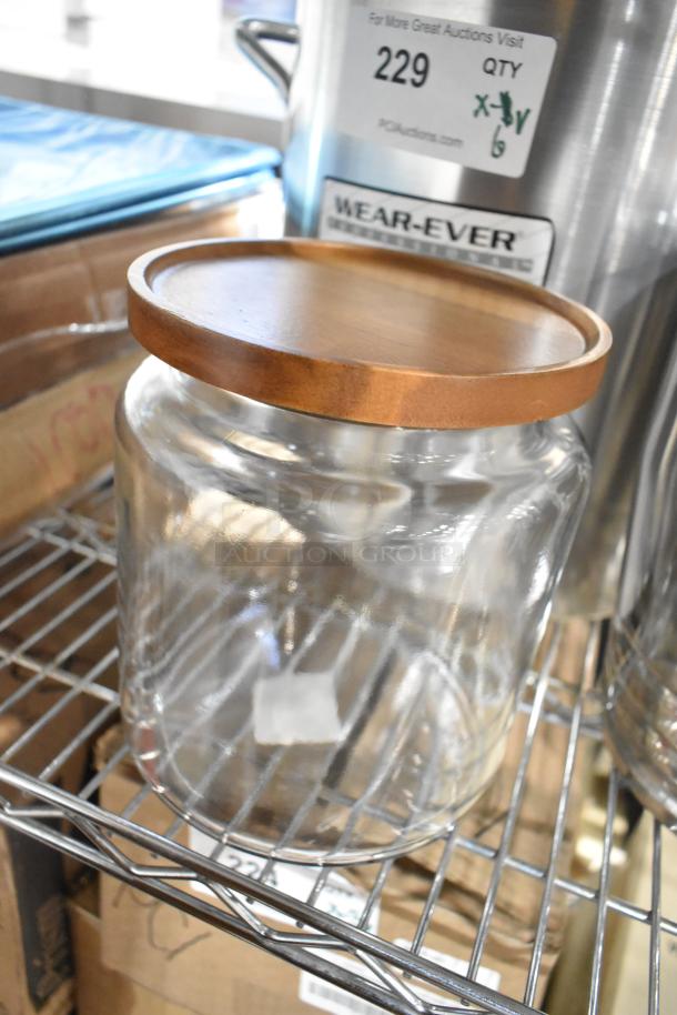 6 new scratch and dent items including Anchor Hocking 96 oz. jar with wooden lid and Vollrath Wearever stock pot.