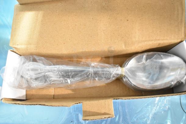 Box containing new Choice Bethany 8 3/8" 18/0 stainless steel serving spoons, wrapped in plastic, minor scratches visible.