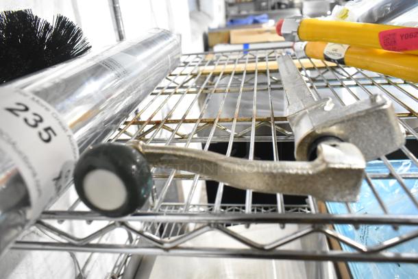 9 brand new scratch and dent items including a Pentair i2000 filtration cartridge, can opener, and gas hoses on shelf.