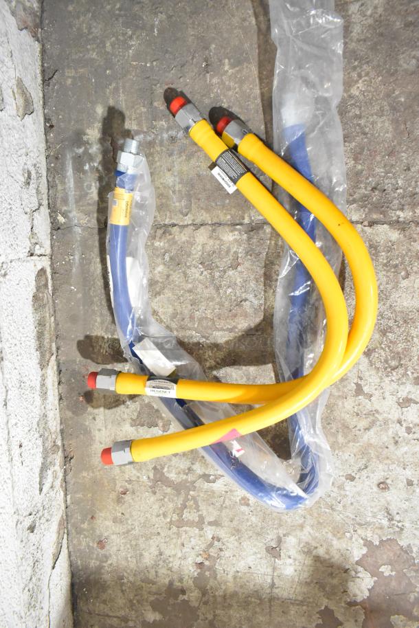 Yellow and blue gas hoses from Dormont 3201675KIT60 in packaging on concrete floor, with visible labels indicating specifications.