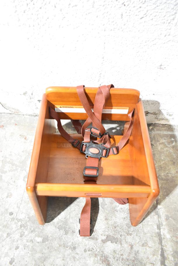 BRAND NEW GET BS-200-MOD-W2 walnut booster seat, T-strap, minor scratches, durable wood, safety warnings visible.