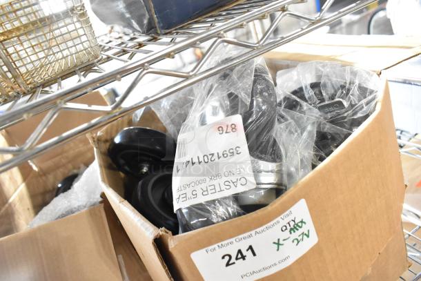 Box of 27 brand new caster wheels, model 35912011471, scratch and dent condition, no brake, on metal shelf.