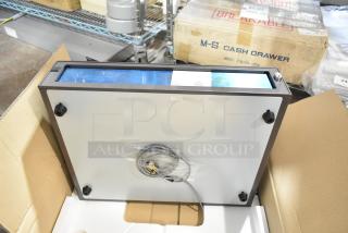 New M-S 73084-054 cash drawer in packaging. Features include cable and key. Model and condition labels visible.