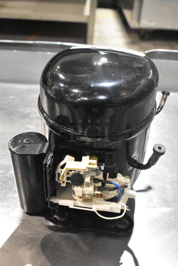 Brand new Cubigel NPY12LR motor, 115-127 volts, 1 phase, in pristine condition, black casing, visible wiring.