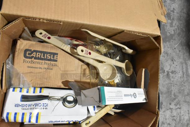 Box of brand new kitchen tools including Vollrath 4780912 tongs, scoopers, dippers. Carlisle FoodService Products label visible.