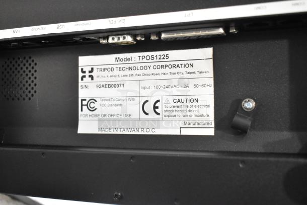 Close-up of a TriPod Technology TPOS1225 monitor label showing model, serial number, input specs, FCC compliance, and caution details.