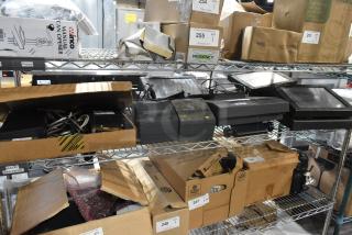 Auction items include POS monitors and receipt printers on metal shelving, boxed and unboxed, various conditions.