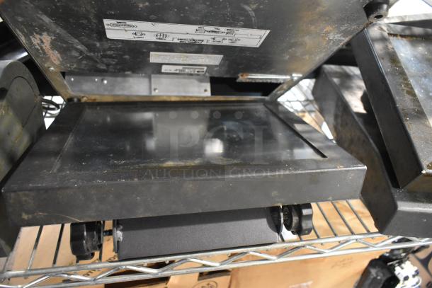 Auction items include POS monitors and receipt printers, showing signs of wear; labeled diagrams visible on metal casing.