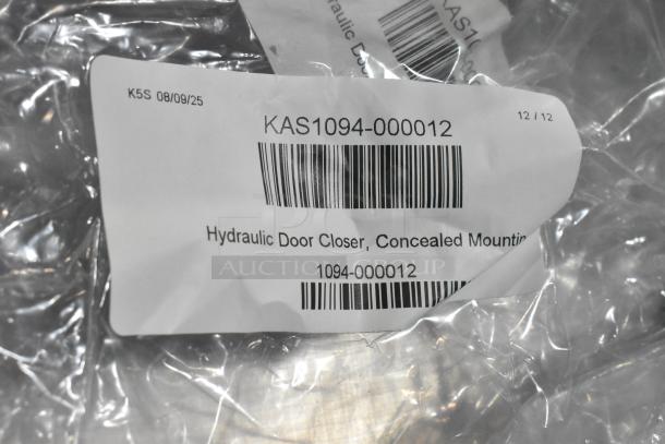 Brand new KAS1094-000012 hydraulic door closer in packaging. Concealed mounting type; labeled with barcode and item number.