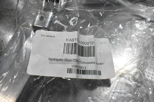 Brand new KAS1094-000012 hydraulic door closer, concealed mounting, in packaging. Includes barcode and label details.
