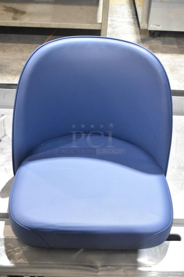 Blue bar stool seat, brand new, with a smooth, upholstered finish and a rounded backrest for comfort.