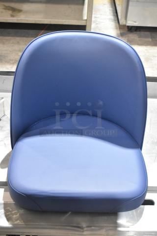 Blue bar stool seat, brand new, with a smooth, upholstered finish and a rounded backrest for comfort.