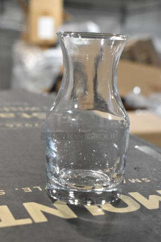 Acopa 4 oz. glass carafe, new scratch and dent item, clear glass, curved design, ideal for serving beverages.