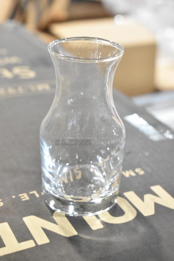 Acopa 4 oz. glass carafe, brand new condition, clear, scratch-and-dent sale, elegant design, perfect for serving.