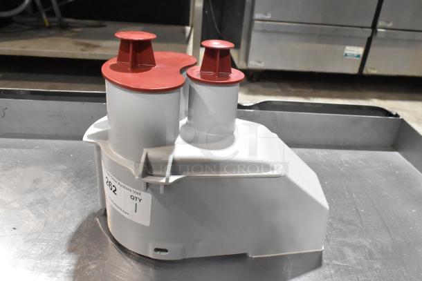 Brand new Robot Coupe gray poly continuous feed head for food processor, slight scratch and dent, auction label visible.