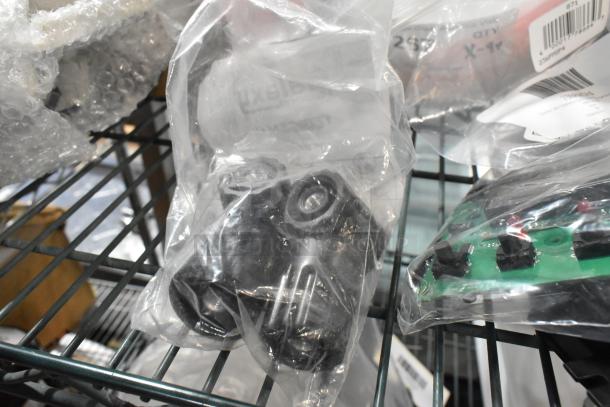 Assorted brand new scratch and dent appliance parts in packaging, including circuit boards and other components.