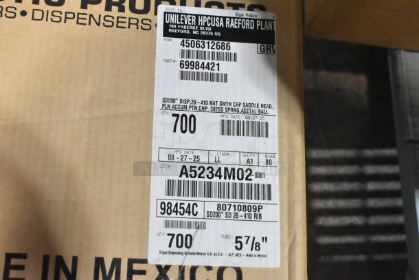 Cardboard box labeled for Unilever HPCUSA Raeford Plant with product details including barcode, part numbers, and manufacturing date.