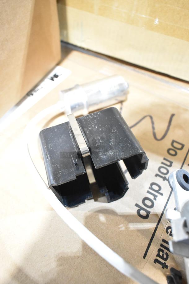 Brand new Vitamix 062467 blender motor, minor scratches and dents. Black casing, visible wiring, quality component.