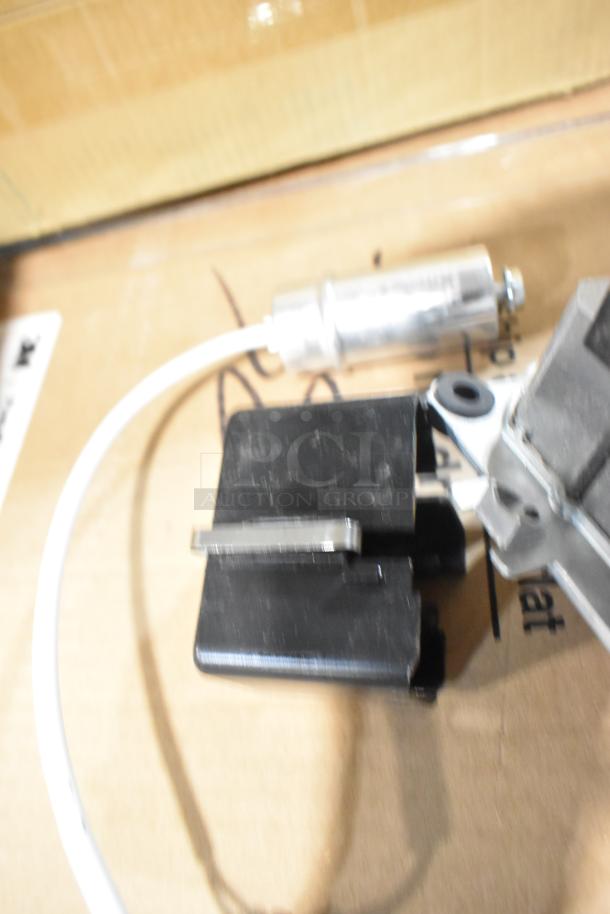 Brand new Vitamix 062467 motor for blenders, scratch and dent condition. Includes connected white cable and metal components.