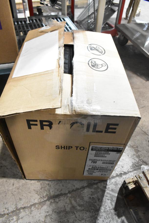 Box labeled "FRAGILE" with shipping details, containing brand new Lancaster Table & Seating Black Chiavari Chair Cushion, 2" thick.