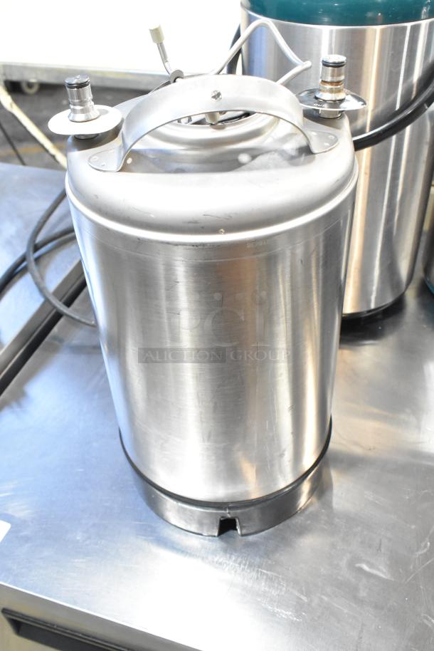 Stainless steel 3-gallon tank with handles and fittings, part of an auction lot with a VitaMix VM0145 blender base.