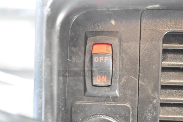 Close-up of a VitaMix VM0145 blender switch showing "OFF" and "ON" positions. Black casing with minor wear visible.