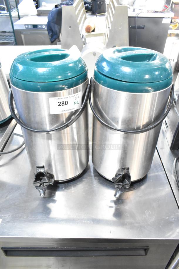 2 stainless steel beverage dispensers with teal lids, tap spouts, and carrying handles. Auction label: "280 QTY x2."